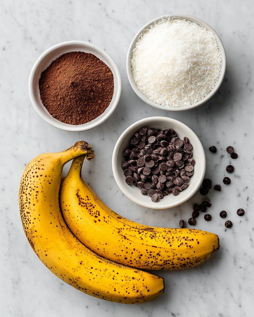 The image shows four main ingredients arranged on a white marbled surface. At the bottom right, there are two ripe bananas with brown spots on their yellow skin. Above the bananas, there are three small white bowls arranged in a triangle. The top bowl is filled with fine white shredded coconut, forming a soft, fluffy layer. Below that, to the left, is a bowl containing dark brown cocoa powder with a grainy texture. To the right is a bowl with shiny, dark chocolate chips, some scattered outside the bowl on the surface. photo taken with an iphone --ar 4:5 --v 7