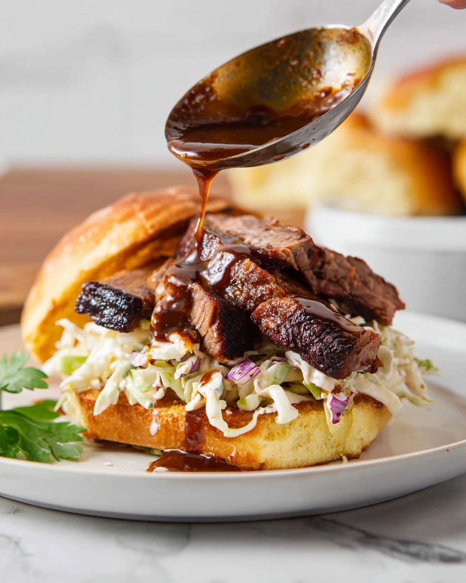 The dish shows an open sandwich on a white plate set on a white marbled surface. The bottom layer is a toasted bun with a golden-brown color and a slightly crisp texture. On top of the bun is a generous layer of creamy coleslaw, made of shredded cabbage with a light sauce, giving it a soft, pale cream color with hints of green and purple. Layered above the coleslaw are thick slices of dark brown, tender cooked meat with a slightly charred surface. A woman’s hand is shown holding a metal ladle pouring rich, dark brown sauce over the meat, with the sauce dripping slightly. In the background, the sandwich top bun with a golden crust is partially visible. Photo taken with an iphone --ar 4:5 --v 7