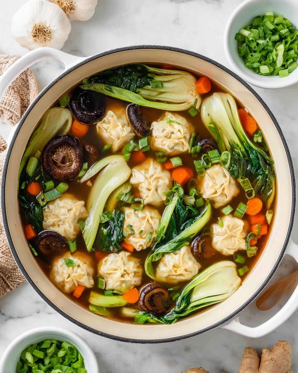 A large white pot filled with clear brown broth holding a mix of ingredients: light beige dumplings floating on top, bright green bok choy leaves with visible veins, thick dark brown mushroom slices, and small round orange carrot slices. The soup also contains scattered chopped bright green onions, adding a fresh touch. The pot rests on a white marbled surface with loose chopped green onions in a small white bowl nearby and a white garlic bulb and piece of ginger visible in the background. The photo taken with an iphone --ar 4:5 --v 7