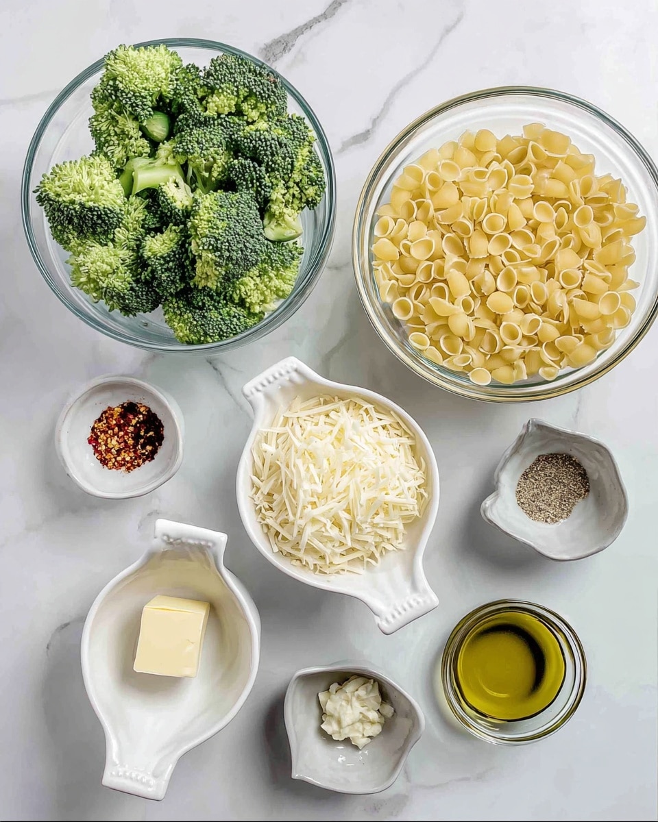 The image shows six white dishes arranged on a white marbled surface. At the top left is a round glass bowl filled with bright green broccoli florets. Next to it on the right is a similar round glass bowl filled with small, round yellow pasta. Below these, in the middle, is a white bowl containing shredded cheese with a small piece of butter on top. To the left and right of this bowl are white dishes with handles; the left one has red chili flakes, and the right one has salt and black pepper. Below and to the left is a small white bowl with minced garlic, and to the right is a small gray bowl with olive oil. The composition is neat and clean with natural lighting. photo taken with an iphone --ar 4:5 --v 7