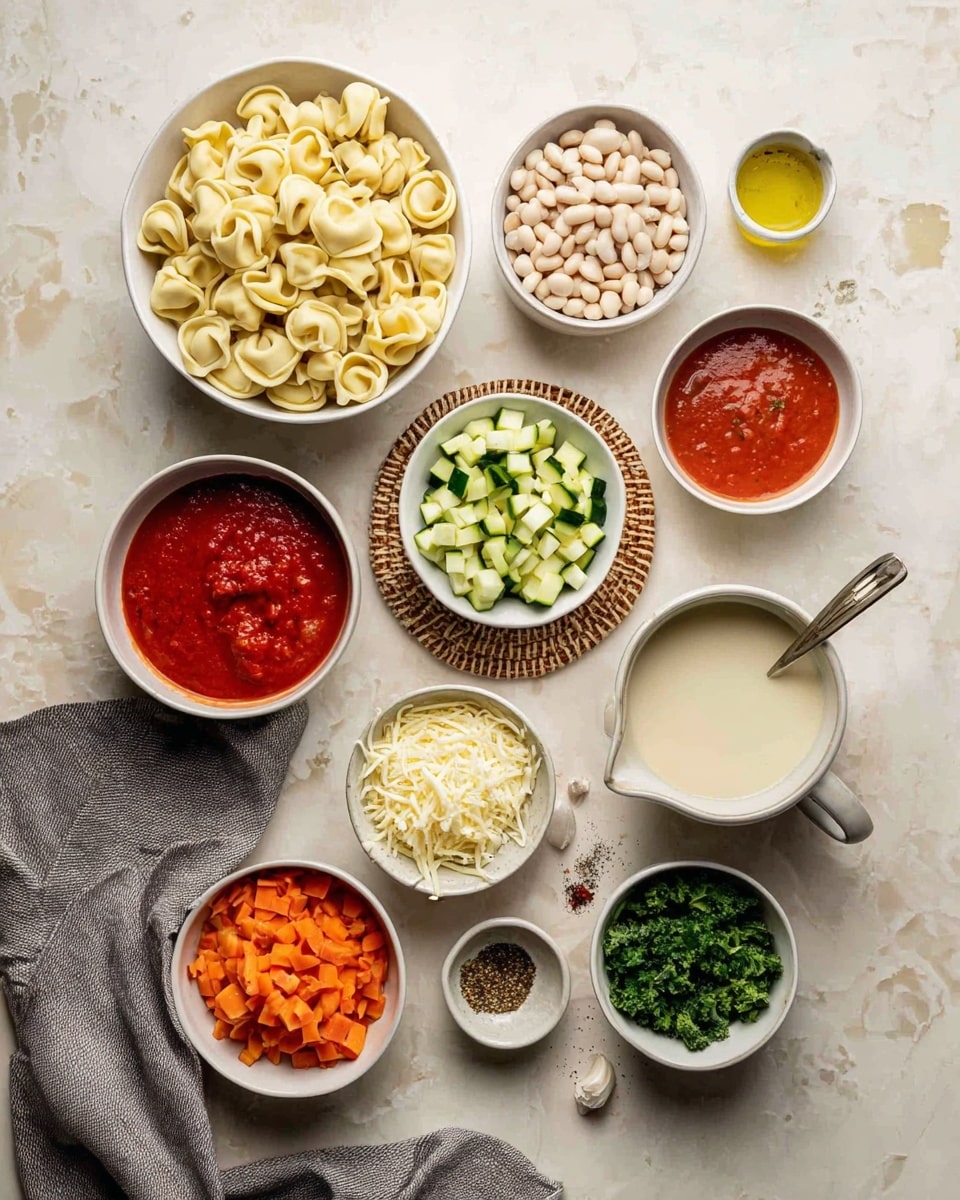 The image shows many small white bowls and cups arranged on a white marbled surface filled with ingredients. There's a large white bowl full of tortellini pasta, a bowl with white beans, a small white bowl with chopped green herbs, and another bowl with chopped onions. A bowl of diced zucchini sits on a woven coaster near a cup of chopped carrots and a small bowl of shredded cheese inside it. There is also a white bowl with red tomato sauce, a cup with yellow broth and a spoon in it, a cup with thick white liquid, a small white cup of tomato paste, and a measuring cup with chopped kale. In addition, two small dishes contain spices and olive oil. A grey cloth is placed near the bowls. Photo taken with an iphone --ar 4:5 --v 7