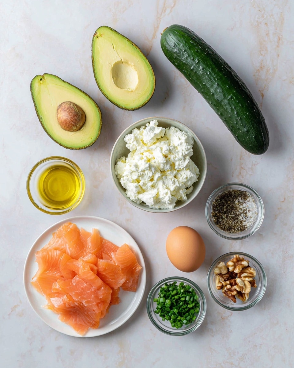 The image shows raw ingredients on a white marbled surface arranged neatly. There are two halves of an avocado with bright green-yellow flesh and a large brown seed in one half, positioned near the top left. A whole dark green cucumber sits horizontally near the top right. Below the avocado, a small round bowl filled with white, chunky cottage cheese is placed. To the left, a small glass container holds golden olive oil. In the bottom left corner, thinly sliced orange-pink smoked salmon is layered on a white plate. Towards the bottom right, there are three small clear glass bowls filled respectively with chopped green chives, mixed chopped nuts, and black pepper. Lastly, a single brown egg is positioned near the right side. Photo taken with an iphone --ar 4:5 --v 7