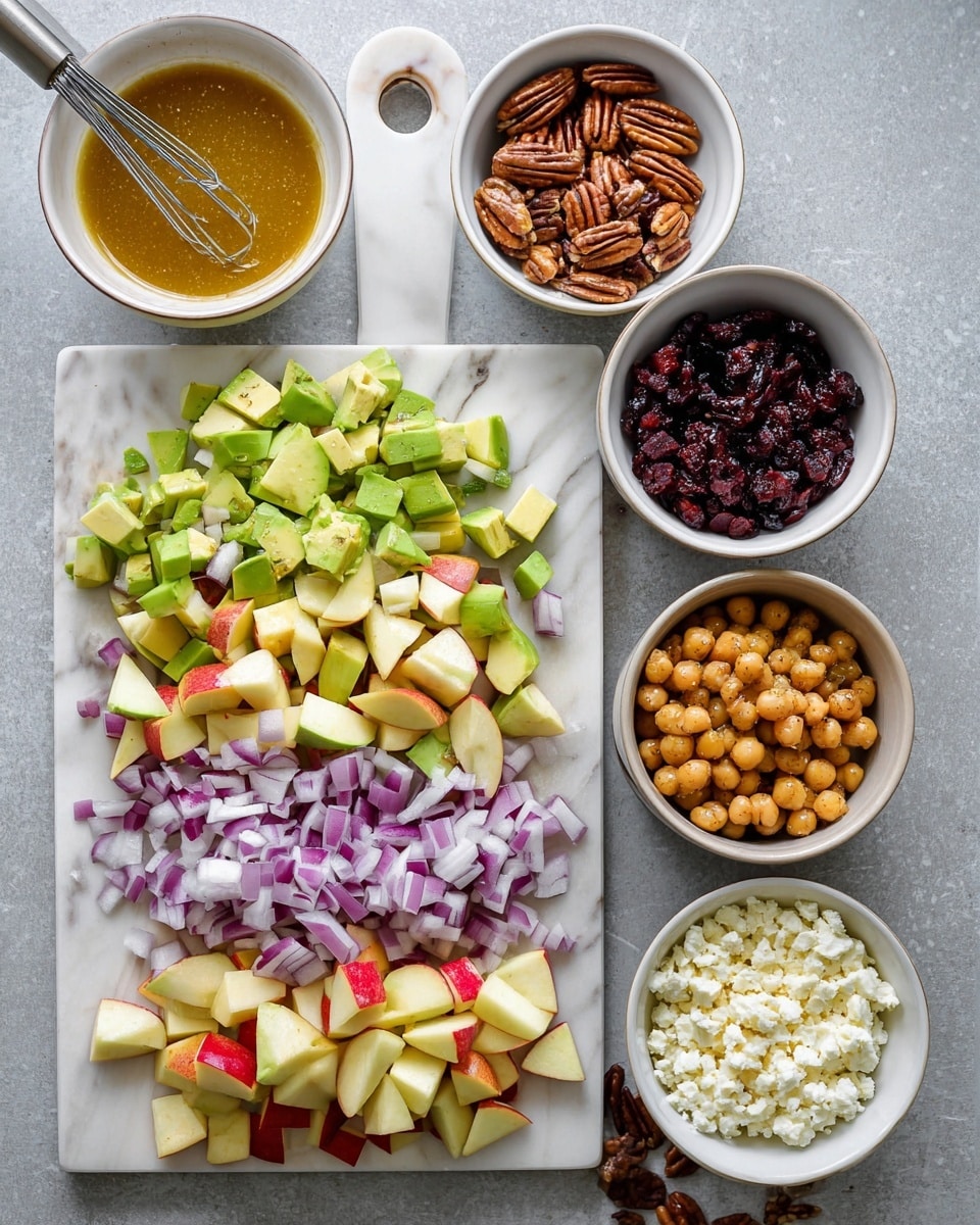 The image shows various salad ingredients neatly arranged on a white marbled surface. On a white marble cutting board, there are three chopped layers from top to bottom: diced purple onions with white edges, light and dark green avocado chunks, and small pieces of red and pale yellow apple. Surrounding the board are five small white bowls with different contents: a bowl with a golden-brown dressing and a small metal whisk, a bowl with pecan halves, a bowl with dark red dried cranberries, a bowl with white crumbled cheese, and a larger bowl holding light beige chickpeas. The overall setup is clean and colorful. photo taken with an iphone --ar 4:5 --v 7