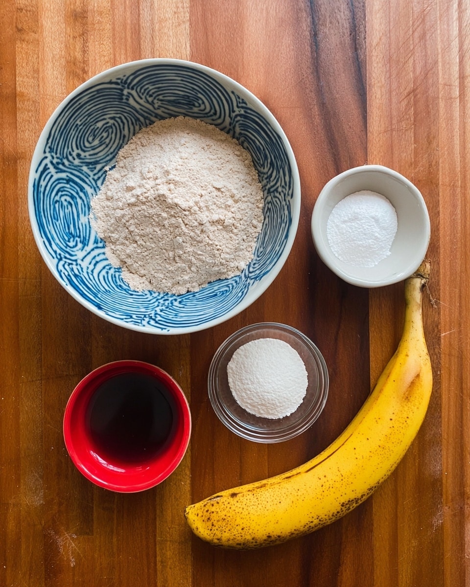 The image shows five cooking ingredients on a wooden surface. At the top center, there is a large bowl filled with light brown flour. Below it and to the left, there is an empty white bowl with blue spiral patterns inside. Next to that on the right, a small clear glass bowl holds two white powders. Below these, a small red bowl contains a dark brown liquid. On the far right, there is a ripe yellow banana with brown spots. The background has a white marbled texture, photo taken with an iphone --ar 4:5 --v 7