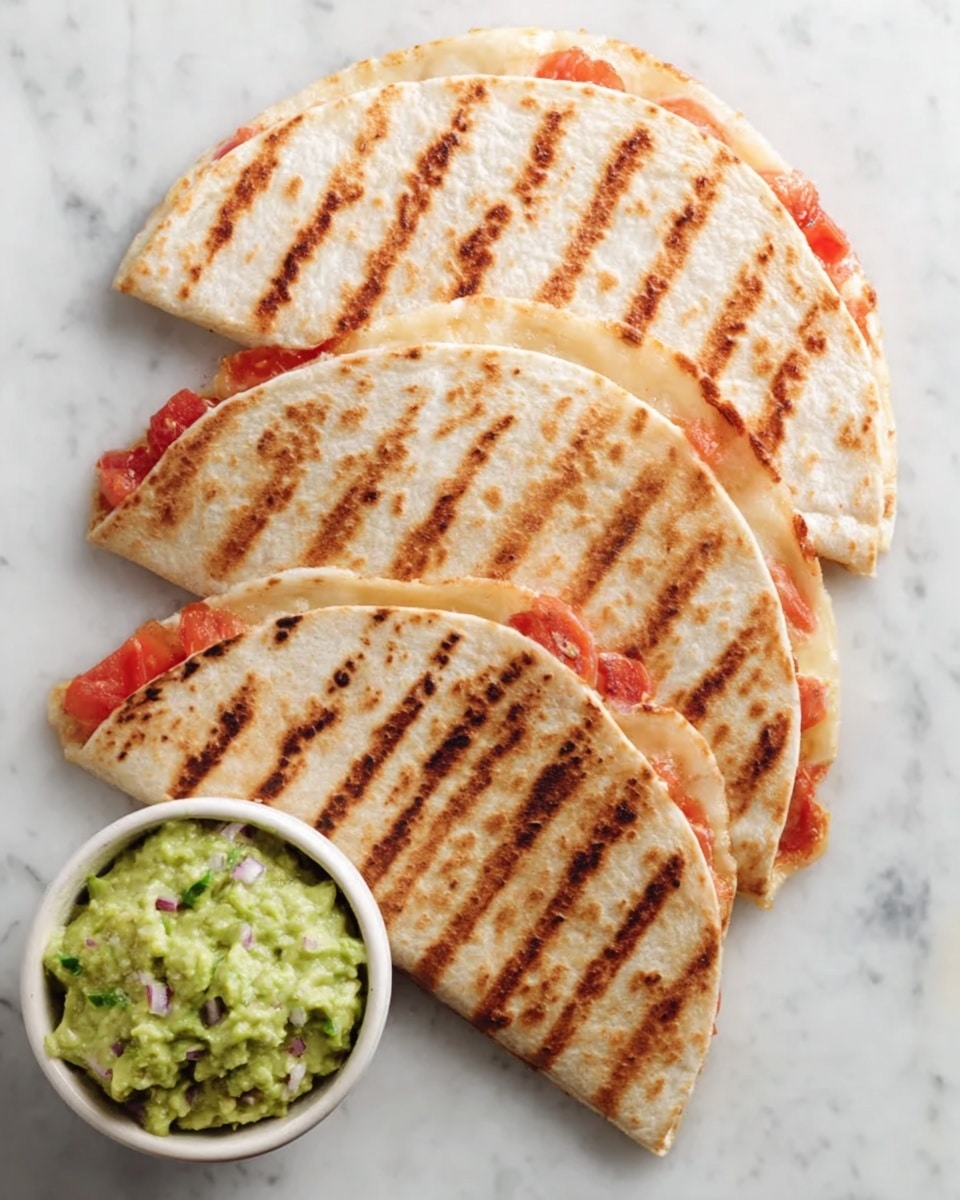 Four grilled quesadillas are laid out in a slightly overlapping row on a white marbled surface. Each quesadilla is folded in half, showing light brown grill marks in neat horizontal lines across the golden-brown surface of the tortillas. Peeking out from the edges are some red tomato slices and melted cheese, giving a hint of the filling inside. Next to the quesadillas is a small white bowl filled with chunky green guacamole that has small pieces of avocado and onion visible. Photo taken with an iphone --ar 4:5 --v 7