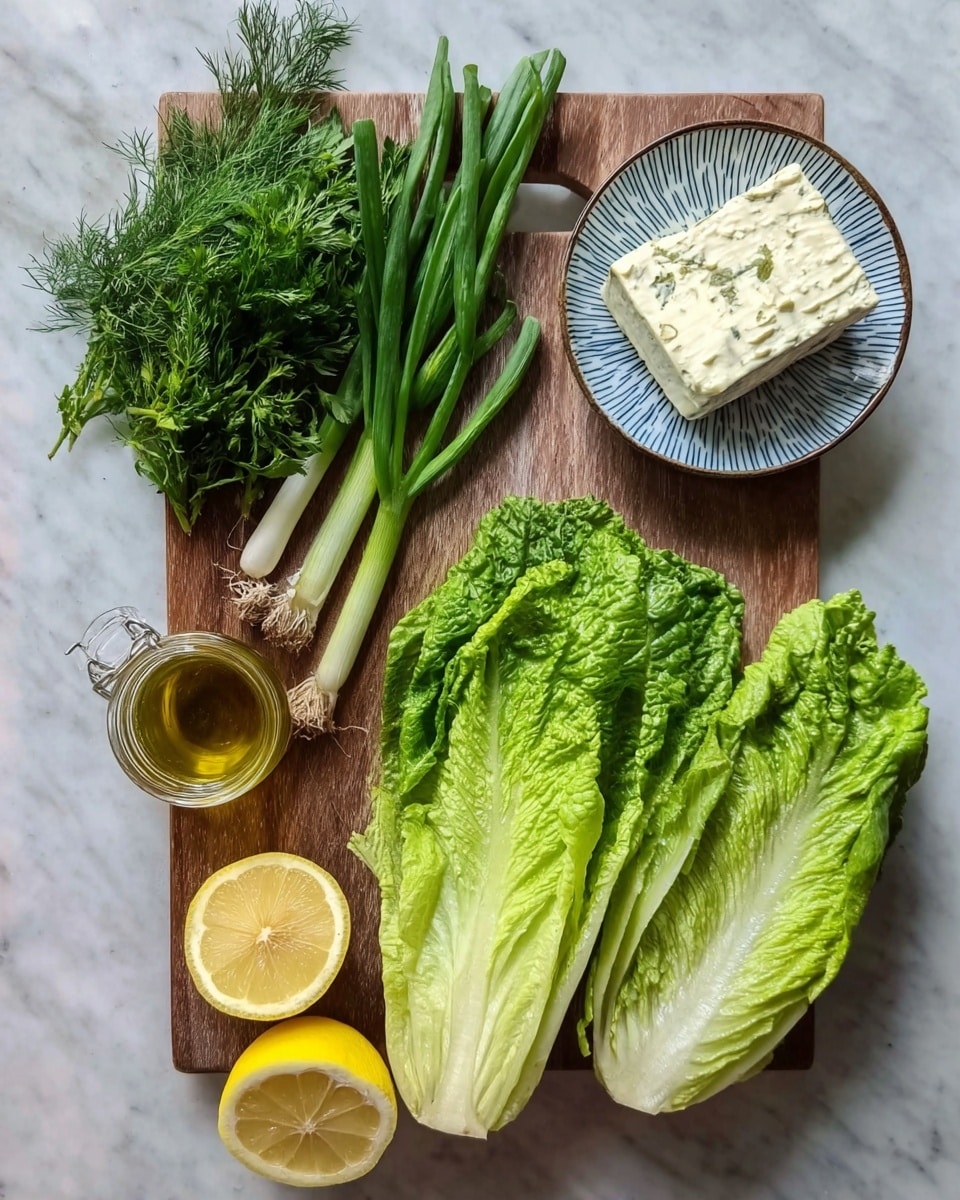 The image shows a wooden cutting board holding fresh green herbs on the top left, green onions in the middle, and two halves of light green romaine lettuce leaves at the bottom right. To the right of the board, there is a white plate with a blue pattern holding a block of white cheese. Below the plate, two lemon halves with a yellow bright color sit next to a small glass jar filled with golden olive oil. Everything is placed on a white marbled surface. Photo taken with an iphone --ar 4:5 --v 7