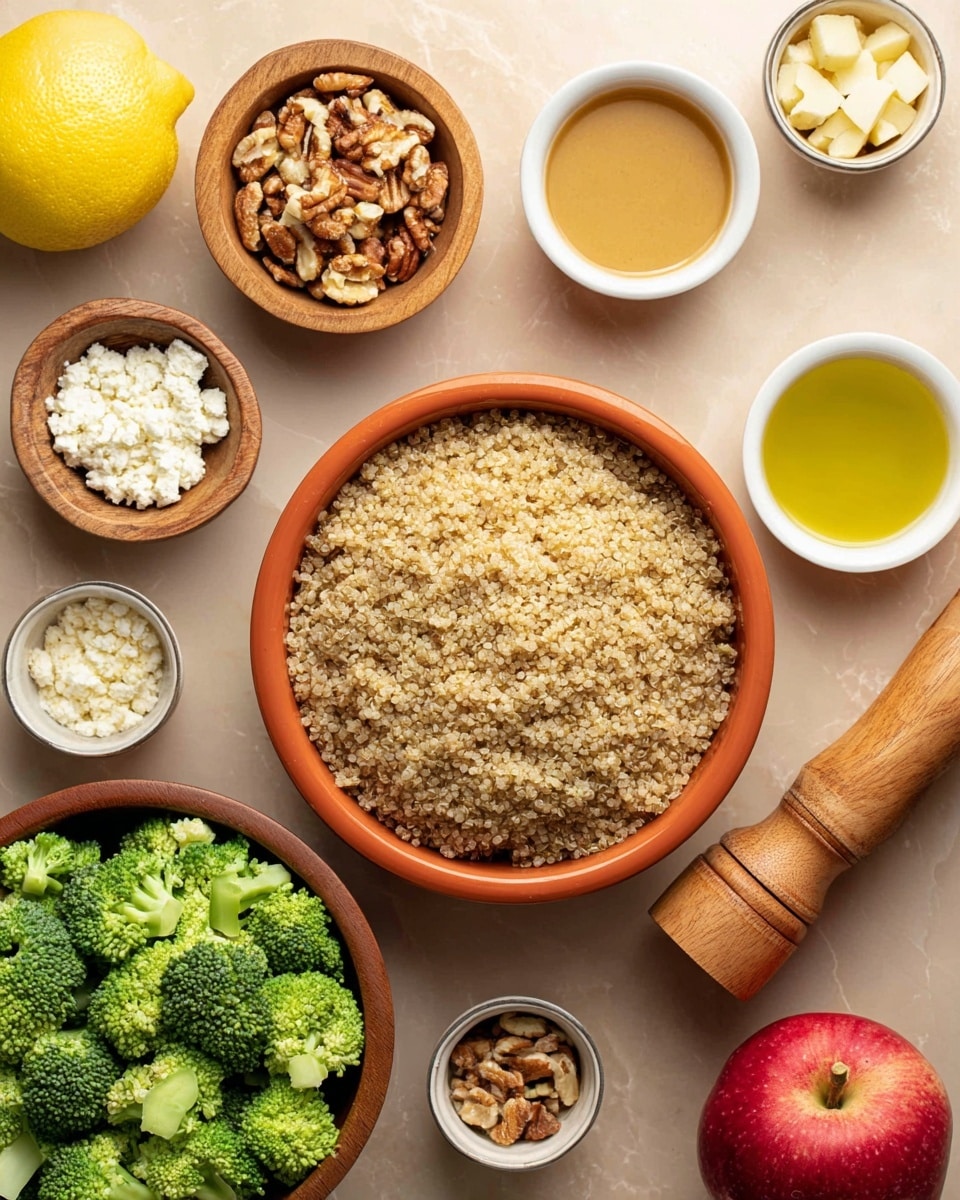A top view of an orange bowl filled with a layer of cooked light brown quinoa in the center, surrounded by several small bowls and items on a smooth beige surface. To the left of the quinoa bowl is a wooden bowl with bright green broccoli florets, a small wooden bowl with white crumbled cheese below it, and a whole lemon. Above and to the right of the quinoa bowl are three small white bowls containing golden yellow liquids and a light brown grainy mustard. Next to the bowls on the right side is a wooden bowl with mixed chopped nuts and a red apple. A tall wooden pepper grinder lies horizontally near the bottom right corner, and to the lower right side is another wooden bowl of broccoli. The setting is neat and colorful with the contrast of green, yellow, red, brown, and white items arranged on a white marbled texture. Photo taken with an iphone --ar 4:5 --v 7