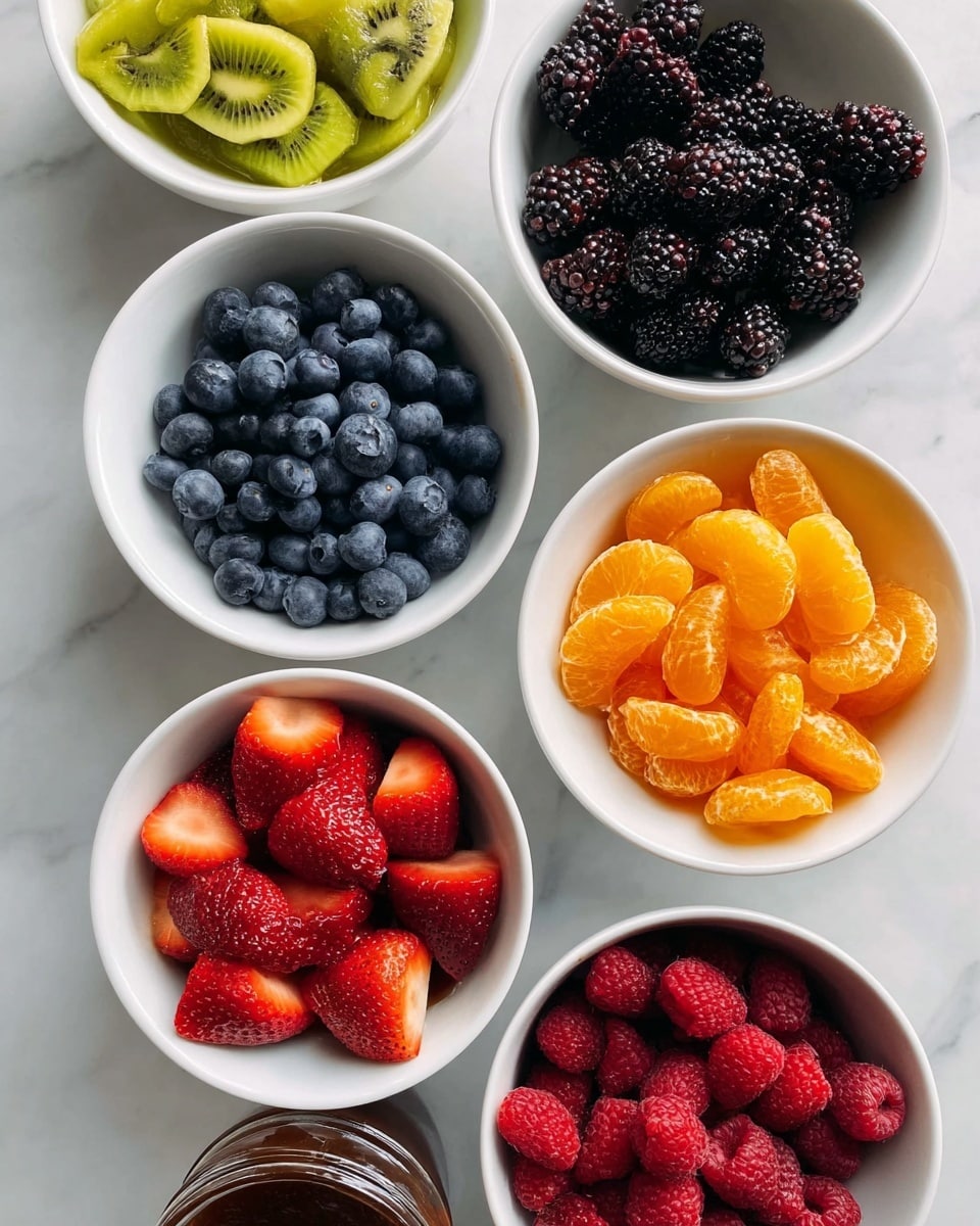 Six white bowls filled with different fruits and a jam jar are arranged on a white marbled surface. One bowl has bright yellow-green kiwi slices arranged in overlapping layers, showing their soft texture. Another bowl holds round, plump blueberries in a deep blue color. A bowl of blackberries shows shiny, dark purple-black berry clusters with a bumpy texture. Next, a bowl of strawberries sits with bright red slices, their seeds and juicy color visible. Another bowl has bright orange peeled mandarin segments, smooth and slightly shiny. The last large bowl holds small, rich red raspberries with a soft surface. A small jar near the edge contains a dark brown jam with a shiny texture. Photo taken with an iphone --ar 4:5 --v 7