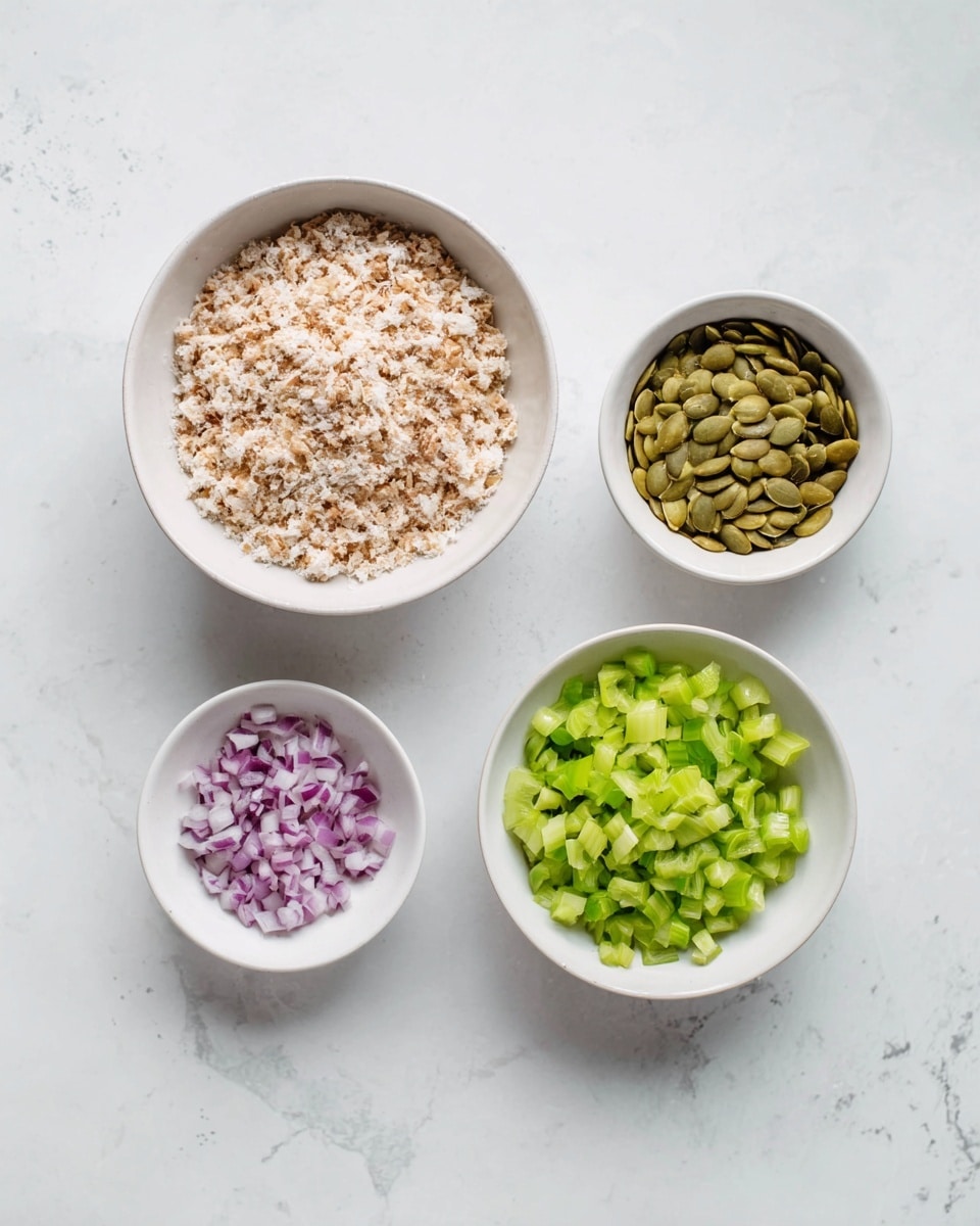 The image shows four white bowls on a white marbled surface, each holding a different ingredient. The largest bowl on the left contains a layer of finely crumbled light brown and white food that looks soft and grainy. To the upper center, a smaller bowl holds a layer of greenish-brown pumpkin seeds with a smooth texture. Below it, another small bowl contains finely diced purple onions with a slightly translucent look. On the right side, a medium bowl is filled with finely chopped bright green celery pieces, showing a fresh, crisp texture. The arrangement is clean and simple with a soft natural light. photo taken with an iphone --ar 4:5 --v 7