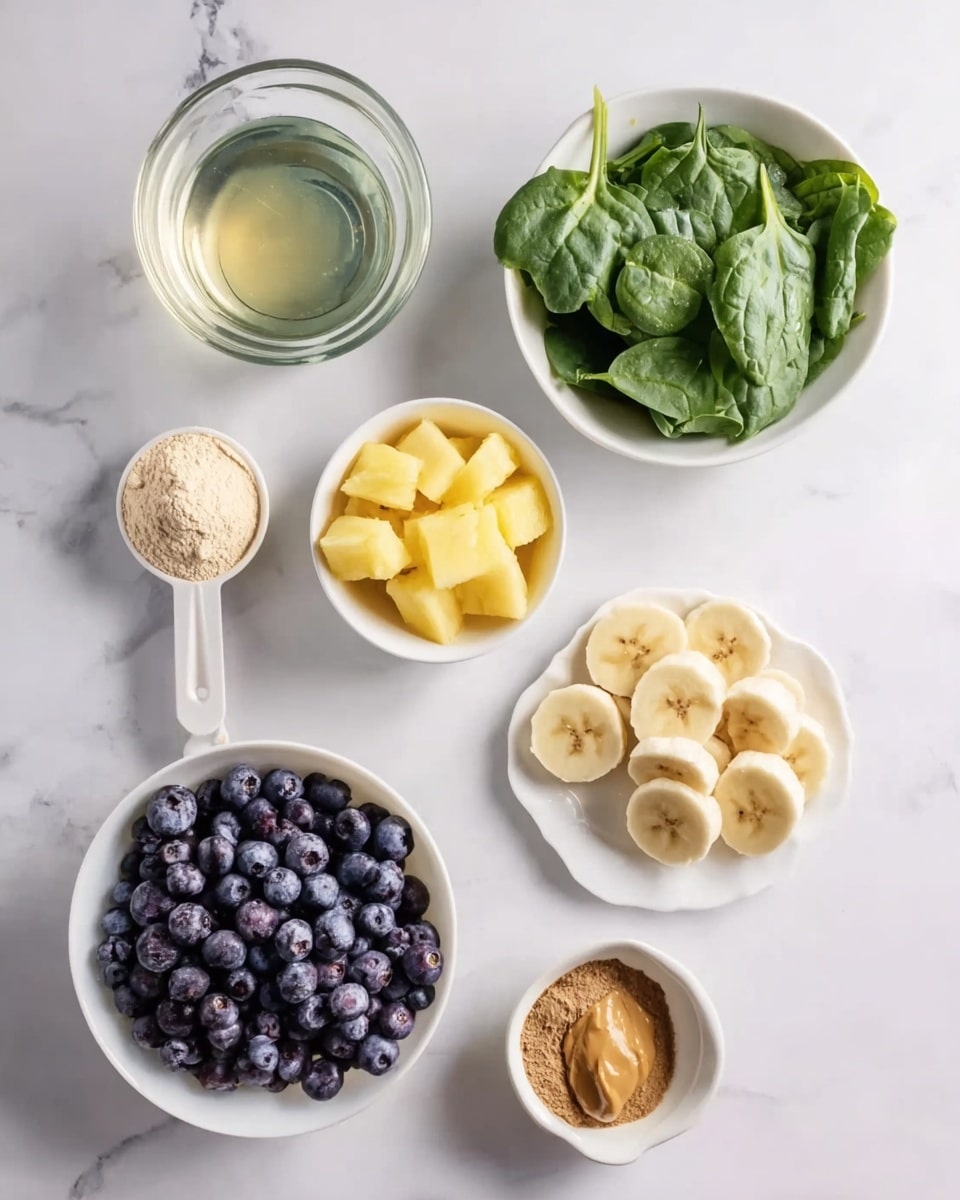 The image shows several small white bowls and a white plate arranged on a white marbled surface. The top left bowl holds a clear liquid with a slight tint. Next to it on the right is a bowl filled with fresh green spinach leaves. Below the liquid, there is a bowl with small yellow pineapple cubes. Below the spinach bowl, a white plate is stacked with sliced banana rounds. To the left of the banana plate is a white bowl filled with deep blue blueberries. At the bottom left, a scoop of light beige powder rests on the surface. Next to it in the middle, a small white bowl contains smooth brown peanut butter. On the bottom right, a unique white bowl holds a mix of light brown powder and a small amount of dark brown powder. photo taken with an iphone --ar 4:5 --v 7