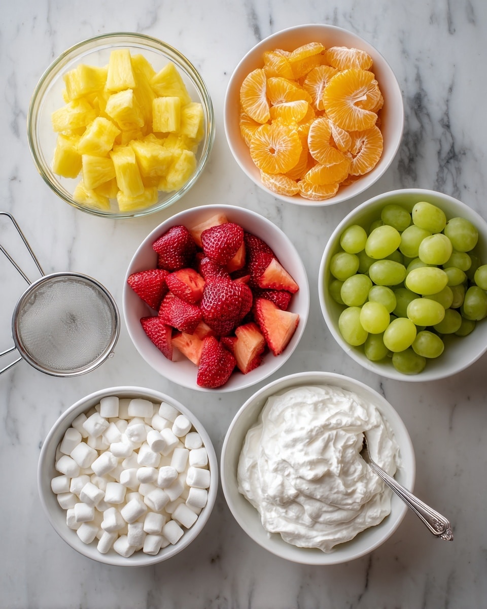 Six white bowls with ingredients are placed on a white marbled surface. Starting from the top left, a glass bowl holds bright yellow pineapple tidbits. To its right, a metal strainer contains shiny, orange mandarin orange slices. Below the pineapple, a white ceramic bowl shows fresh, red sliced strawberries. To the right of this, another white bowl is filled with green grapes. On the bottom left, a white bowl contains small, white mini marshmallows. Finally, on the bottom right, a white bowl holds fluffy white whipped topping with a silver spoon inside. Near the bottom center, a small brown paper bag contains white vanilla pudding mix. photo taken with an iphone --ar 4:5 --v 7