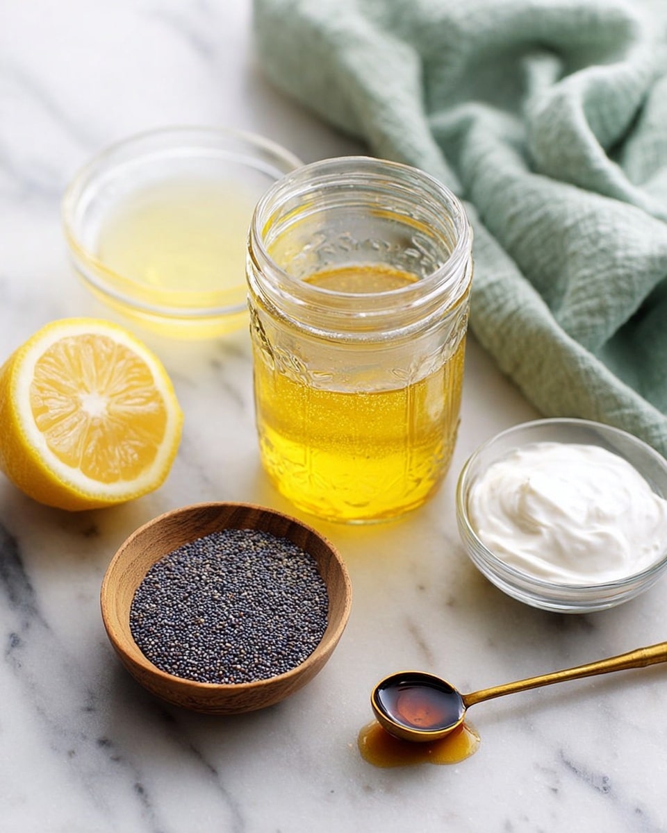 A clear glass jar filled partially with golden yellow liquid stands near the center, surrounded by ingredients on a white marbled surface. To the left of the jar is a bright yellow lemon sliced in half, behind a small clear bowl holding a pale yellow liquid. In front and slightly right of the jar, there is a small round wooden bowl filled with tiny, dark blue-gray poppy seeds. Further to the right, a small clear bowl contains thick white creamy substance. At the bottom right, a gold measuring spoon with a wooden handle holds a small amount of dark brown liquid. A soft pale green cloth is casually folded in the background. Photo taken with an iphone --ar 4:5 --v 7