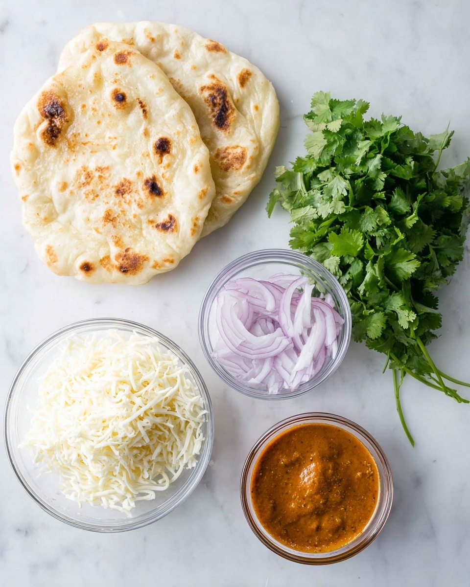 Two pieces of soft, light tan naan bread with brown spots are stacked loosely on a white marbled surface at the top left. Below them, a bunch of fresh, bright green cilantro leaves rests spread out. To the right of the cilantro, there is a small clear glass bowl filled with thin, curly rings of purple onion. Below the onion bowl, a similar clear bowl holds thick, reddish orange curry sauce with a smooth yet slightly chunky texture. At the bottom left, a clear bowl contains a heap of shredded white cheese, fluffy and soft in appearance. All items are arranged on a white marbled surface with bright natural light. Photo taken with an iphone --ar 4:5 --v 7