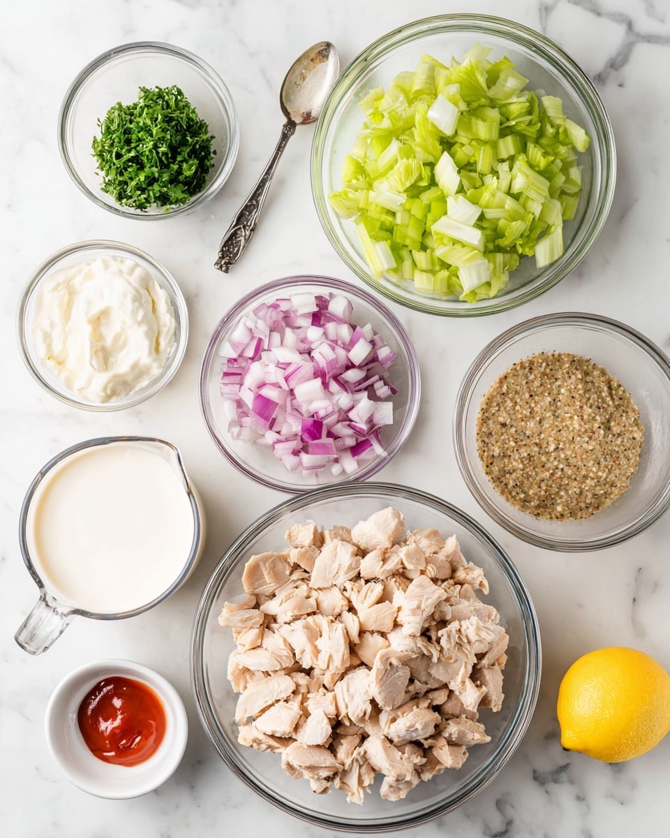 The image shows an overhead view of various clear glass bowls and a measuring cup on a white marbled surface, each filled with different ingredients. In the largest bowl at the bottom right, there is a generous pile of small light beige cooked chicken pieces. Above it, a medium bowl holds finely chopped green herbs. To the left, there is another bowl with chopped celery in a pale green shade, and next to it, a bowl of finely chopped red onions with pink and white layers. Below these, a small bowl contains a grainy mustard sauce with a tan and brown speckled texture. A smaller bowl at the bottom left has plain white creamy yogurt. In the center, a clear measuring cup holds a white liquid, likely dressing. Near the bottom left corner, a small bowl has a bright red sauce, and beside it rests a halved lemon with a bright yellow rind. The whole scene is clean, simple, and organized for recipe preparation. Photo taken with an iphone --ar 4:5 --v 7