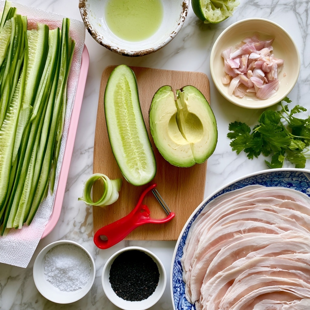 The image shows fresh cooking ingredients neatly spread on a white marbled surface. There is a pink tray with long, thin, bright green cucumber strips resting on paper towel. In the middle, a wooden board holds a halved cucumber with light green flesh, and two avocado halves showing creamy light green inside. A red Y-peeler with a cucumber peel curl is placed on the board. White small bowls hold coarse white salt and black sesame seeds. Near the top, a white bowl with a dirty edge contains lime juice, with half a squeezed lime nearby. On the right, a creamy white bowl holds diced shallot, next to a small bunch of green cilantro leaves. A blue and white plate at the bottom right has thin turkey deli slices arranged in layers with pale pink and white colors. The whole setup is clean, fresh, and vibrant. Photo taken with an iphone --ar 4:5 --v 7