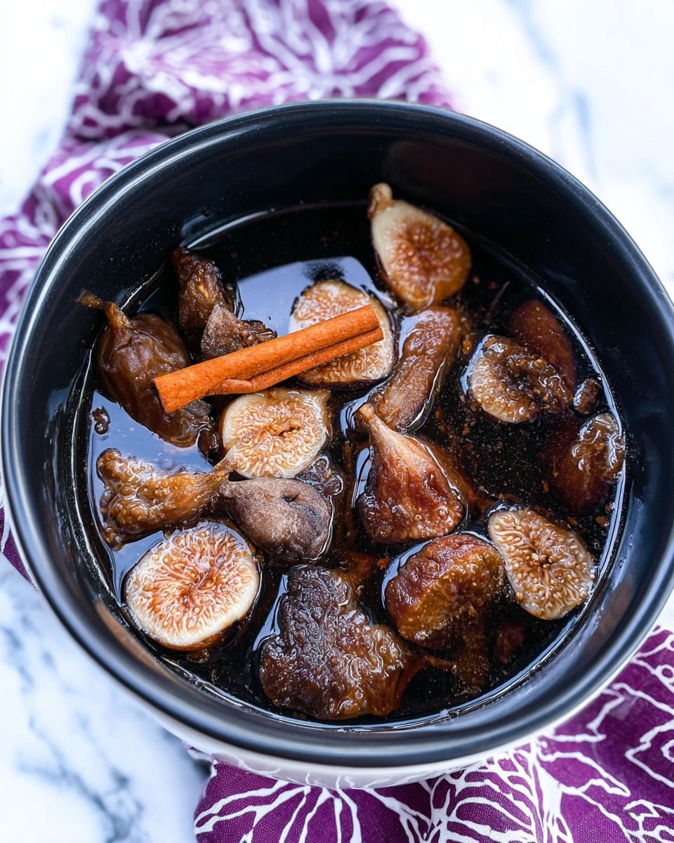 A close-up of a black pot filled with dark brown liquid and many pieces of dried figs soaked inside. The figs vary in size and shape, with some showing their seeds and wrinkled textures. A single cinnamon stick with a reddish-brown color lies in the middle on top of the figs. The pot sits on a purple and white patterned cloth with a white marbled surface underneath. Photo taken with an iphone --ar 4:5 --v 7