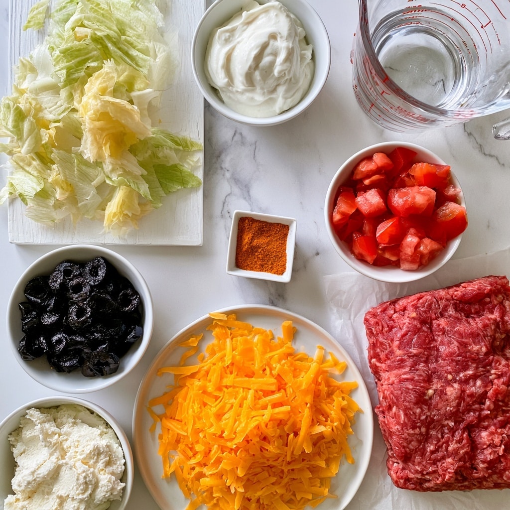 A white wooden board holding torn light green and pale yellow lettuce is placed on the left, near a small white bowl of smooth white sour cream at the top middle. To the right, a clear glass measuring cup with water marked in red sits near the top right. Below the sour cream, a small white bowl contains small, bright red chopped tomatoes. Near the center bottom, a tiny white square bowl holds orange taco seasoning powder. To the left and below the tomatoes, a white bowl holds black sliced olives with a shiny texture. At the bottom left, a small white bowl contains soft cream cheese with a rough surface. Near the center bottom is a wide white plate full of shredded bright orange cheddar cheese. Finally, at the lower right, a thick slab of red ground beef with a slightly coarse texture rests on parchment paper, all placed on a white marbled background. Photo taken with an iphone --ar 4:5 --v 7