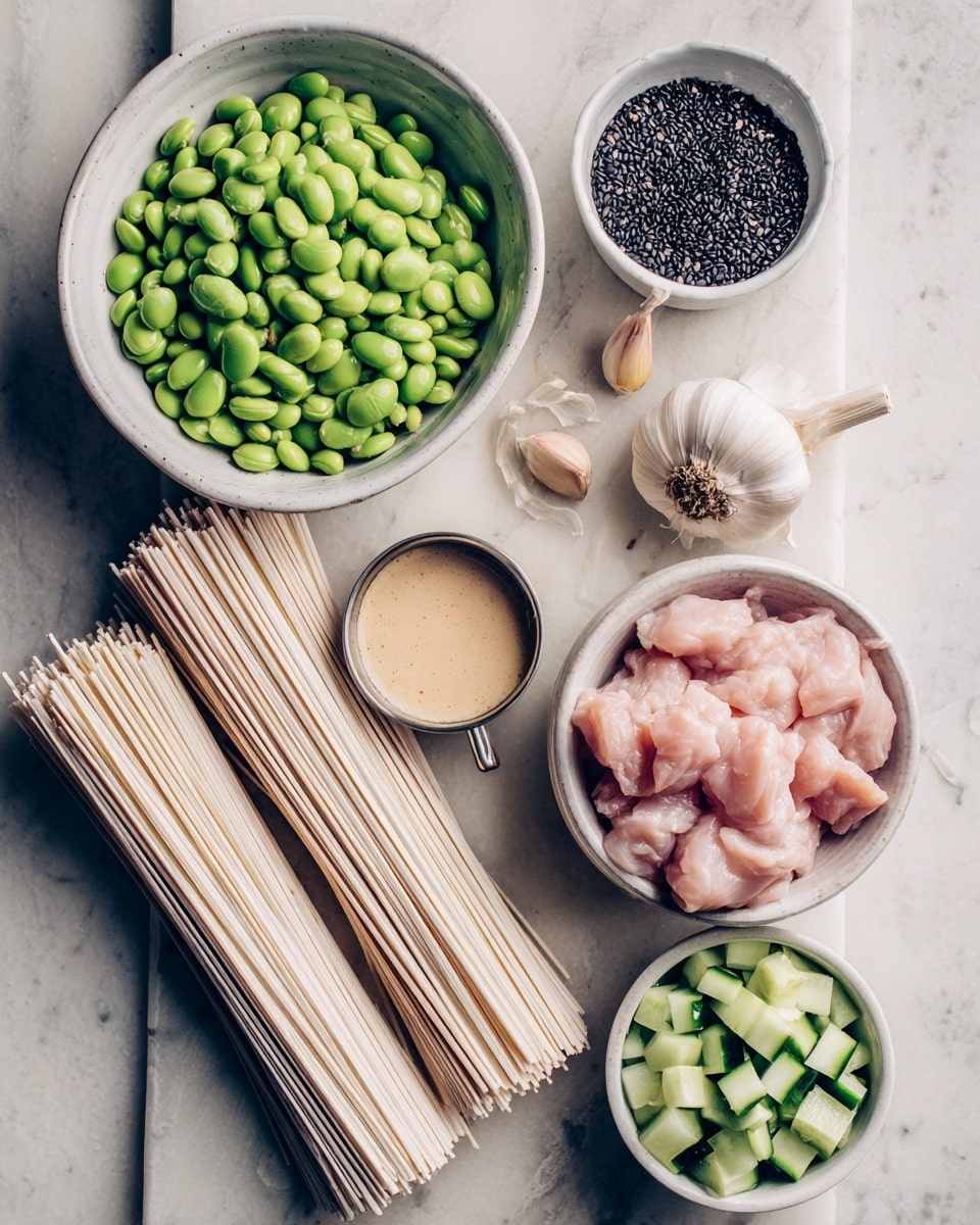 The image shows a collection of fresh ingredients arranged on a white marbled surface. In the top left, there is a white bowl full of bright green edamame beans. Below that, two bundles of uncooked white noodles lay side by side. To the right of the noodles, there is a small white bowl filled with black sesame seeds. Above this bowl, a small metal cup holds a smooth beige sauce. To the right of the sauce, there are peeled garlic cloves resting beside a bulb of garlic. In the bottom right, a white bowl contains raw light pink chicken pieces. Lastly, in the bottom center, another white bowl is filled with chopped green cucumber pieces. The photo is taken with an iphone --ar 4:5 --v 7