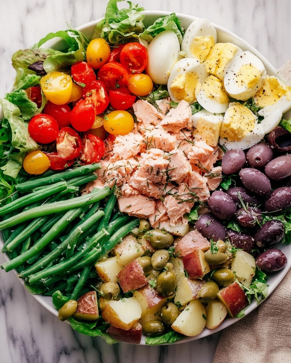 The dish is arranged in a white bowl on a white marbled surface. Starting at the top left, there is a layer of bright green lettuce leaves topped with a mix of halved red and yellow cherry tomatoes, with a fresh leafy green underneath. Next to it, toward the center, chunks of pinkish cooked salmon are placed with a simple dressing on top. To the right of the salmon, there are quartered hard boiled eggs sprinkled with black pepper. Below the eggs, a cluster of dark purple olives is arranged alongside large green caper berries with long stems. At the bottom right, there is a mix of red potatoes cut into chunks, dressed with herbs and small capers. Along the bottom left side, vibrant green beans are neatly piled. Each element is fresh and colorful, creating a balanced and inviting look. Photo taken with an iphone --ar 4:5 --v 7