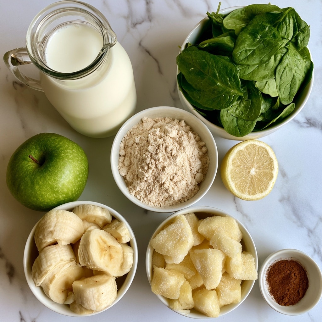 The image shows several ingredients placed separately on a white marbled surface. At the top left is a clear glass jug filled with white unsweetened almond milk. To the right is a white bowl filled with fresh green spinach leaves, bright and crisp. Below the jug is a whole green apple with a shiny peel. Next to the apple is a white bowl with light beige vanilla protein powder, loosely piled. Below the protein powder is a white bowl with thick banana slices, pale yellow with soft texture. To the right of the protein powder is a halved lemon, showing its juicy, light yellow inside. Below the lemon is a white bowl filled with frozen pineapple chunks, with a frosty pale yellow look. At the bottom right is a small white bowl with a small pile of ground cinnamon in warm brown color. All items are arranged in a loose cluster, clean and fresh. photo taken with an iphone --ar 4:5 --v 7