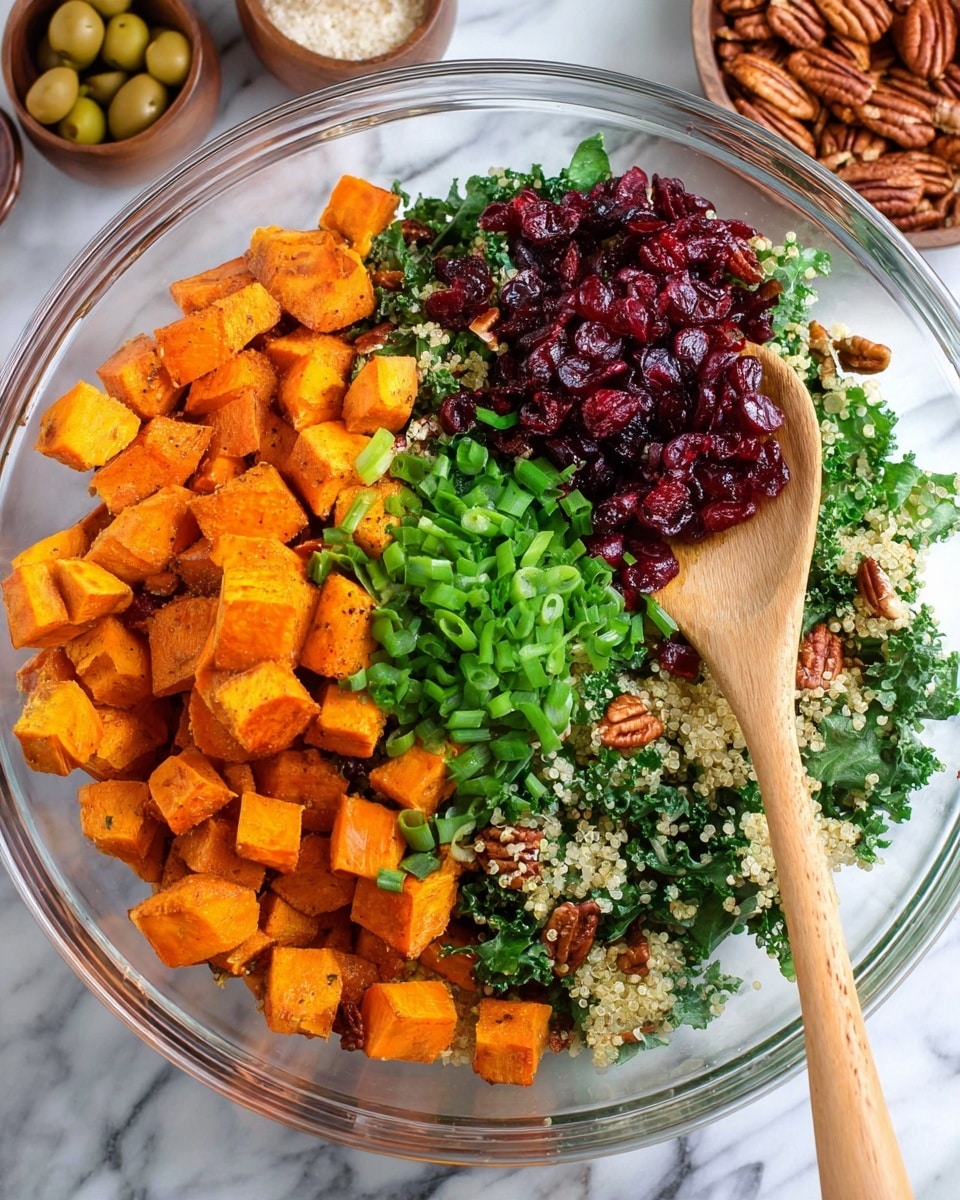 A clear glass bowl holds a colorful salad with four main layers arranged side by side. The left layer shows bright orange roasted sweet potato cubes with a slightly crispy texture. Next to it, there is a pile of fresh green chopped scallions, thin and bright. Moving right, deep red dried cranberries sit on top of chopped dark green kale mixed with light beige quinoa grains scattered throughout. A wooden spoon is resting on the right side inside the bowl. The bowl is placed on a white marbled surface, with small bowls of pecans and olives slightly visible in the background. Photo taken with an iphone --ar 4:5 --v 7