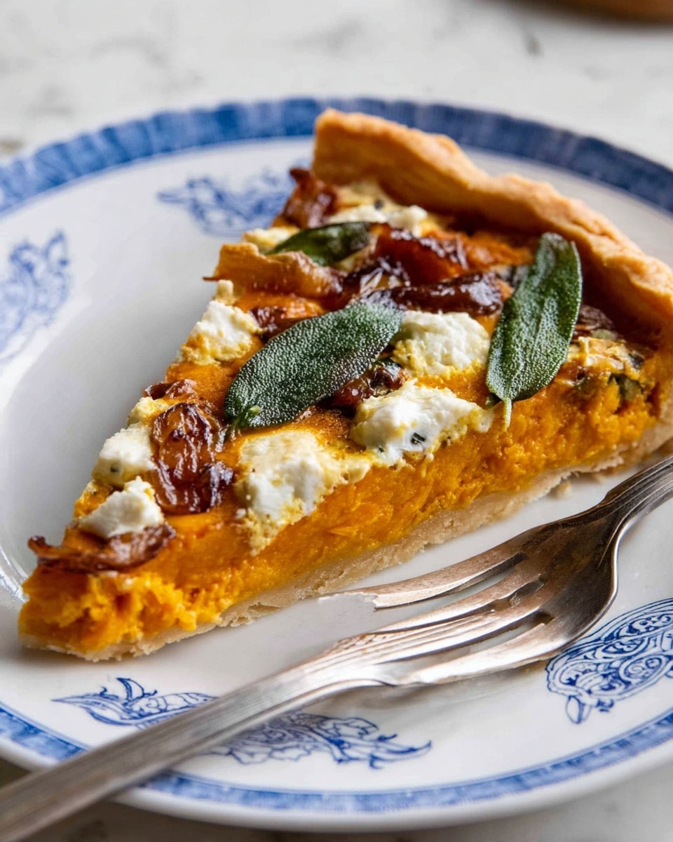 A round rustic tart with a golden-brown crust folded over the edges, showing a bright orange pumpkin filling spread evenly inside. Patches of caramelized dark brown sauce and small white chunks of cheese are scattered on top, along with a few big dark green sage leaves laid flat across the surface. One slice is slightly pulled away, revealing the thick filling and flaky crust underneath. The tart is on white parchment paper, placed on a wooden surface changed to white marbled texture. photo taken with an iphone --ar 4:5 --v 7