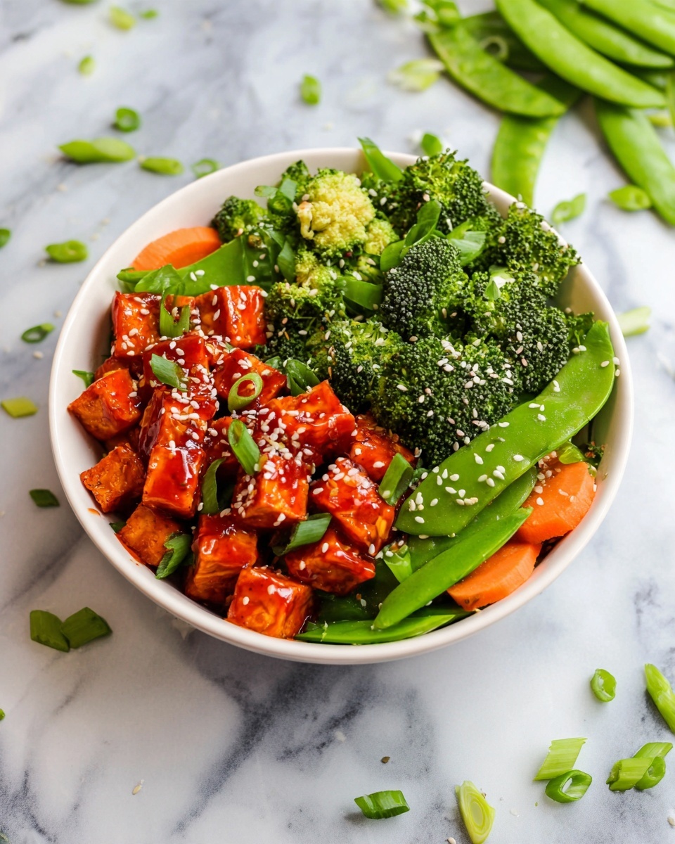 In a white bowl, bright orange cubes of tofu coated in red sauce form the top right layer, sprinkled with white sesame seeds and chopped green onions. To the left, a mix of vibrant green broccoli florets and snap peas create a fresh, textured layer with some slices of orange carrot peeking through. The bowl is set on a white marbled surface with scattered snap peas and green onion pieces around it. Photo taken with an iphone --ar 4:5 --v 7
