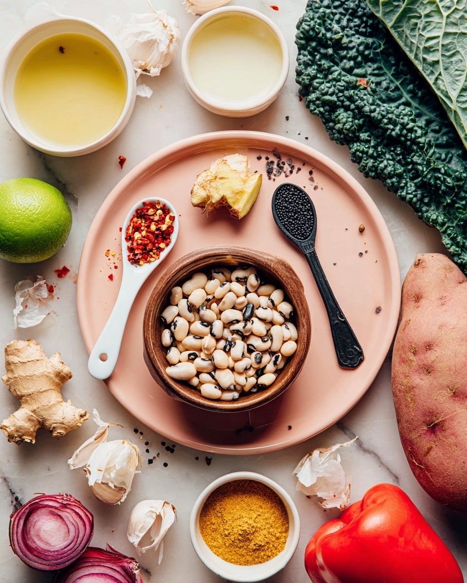 A light pink plate holds multiple small items: a white spoon with red chili flakes, a small piece of fresh ginger root, and a black spoon with coarse salt. A brown bowl filled with black-eyed peas sits at the bottom center of the plate, while a small white bowl with yellow spice powder rests near it. Around the plate, various fresh ingredients are scattered, including a halved lime with bright green flesh, a dark green leaf of kale, half a white onion, cloves of garlic, a red potato, and a red bell pepper. Above, a small white bowl contains pale yellow liquid, and another small bowl has white creamy sauce. The whole setup is placed on a white marbled surface. Photo taken with an iphone --ar 4:5 --v 7