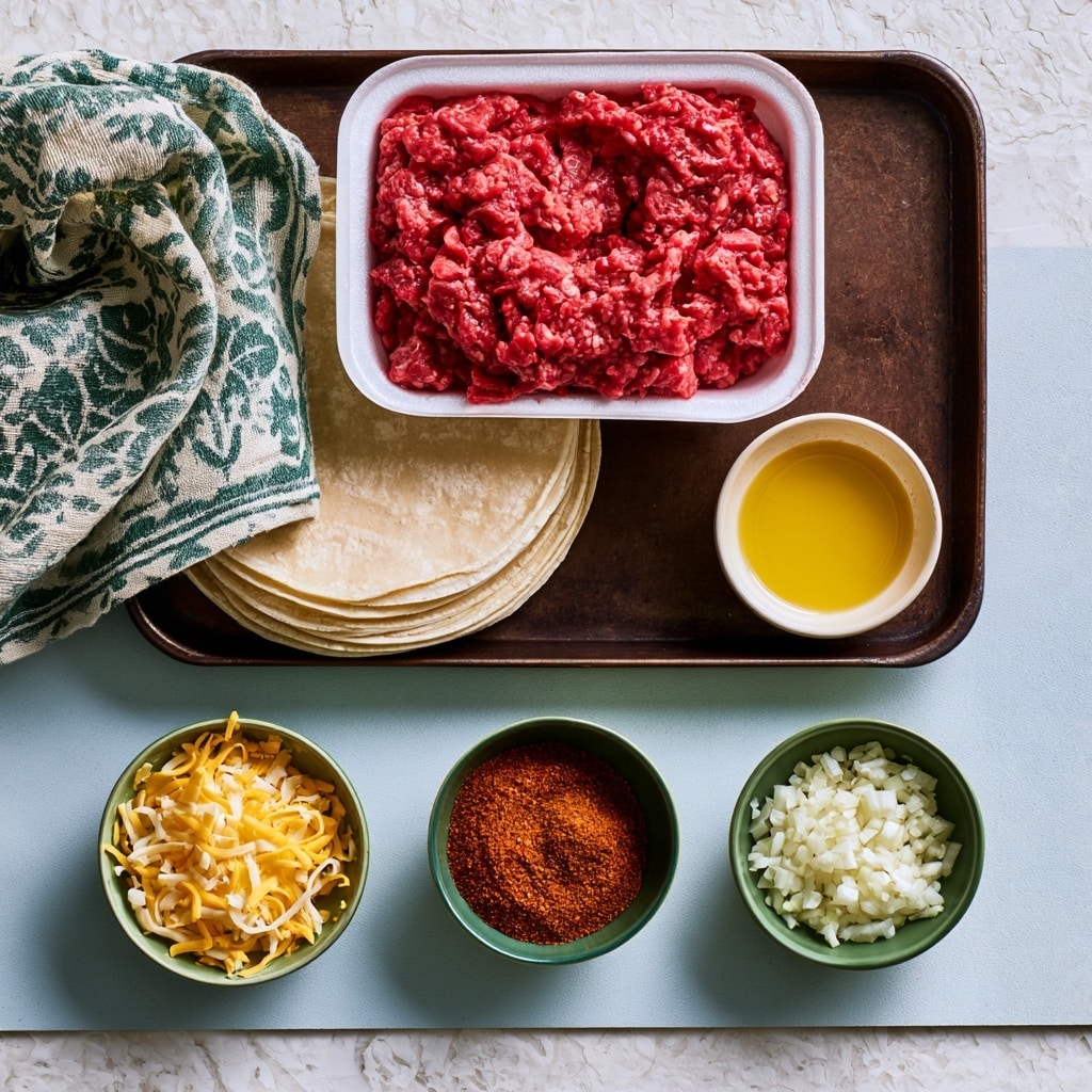 A dark brown tray holds a white foam container filled with bright red raw ground beef at the top center. Below it, a stack of pale tortillas partially covered with a green and white patterned cloth is set on the left side. To the right of the tortillas, a small white bowl with yellow oil is placed on the tray. Below the tray on a light blue surface, three small green bowls are arranged: the left bowl contains fresh yellow and white shredded cheese, the middle bowl holds a reddish-brown taco seasoning powder, and the right bowl has chopped white onions. The whole setup is on a white marbled texture. photo taken with an iphone --ar 4:5 --v 7